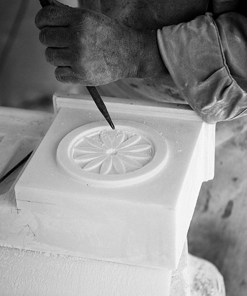 Carver carving intricate stone patterns